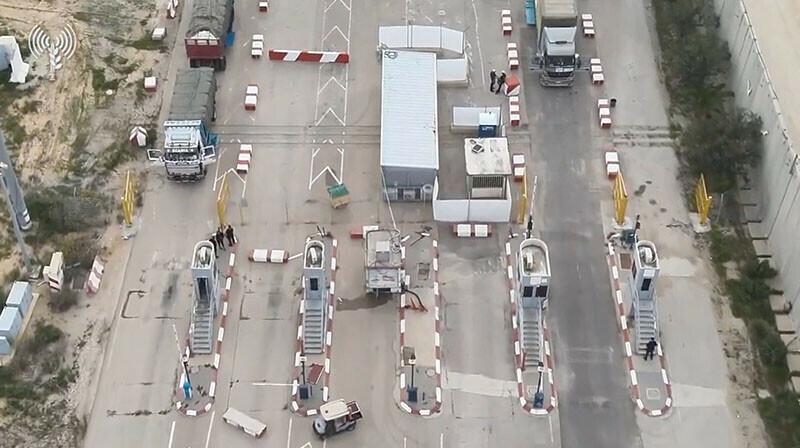 Humanitarian aid trucks wait in line to be inspected at the Kerem Shalom crossingon the border between Israel, Gaza and Egypt on December 12, 2023. &mdash; Reuters via COGAT
