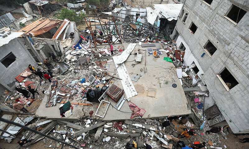 Palestinians inspect the damage at the site of Israeli strikes on houses in Khan Younis in the southern Gaza Strip, December 13, 2023. &mdash; Reuters
