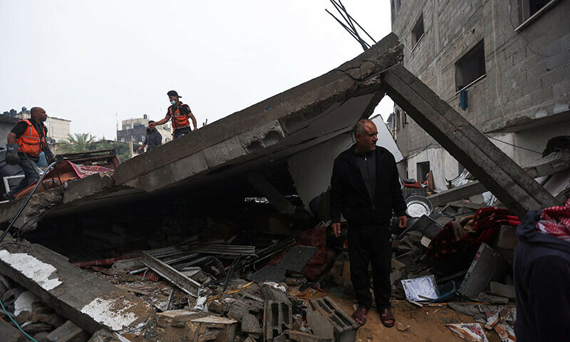 Palestinians inspect the damage at the site of Israeli strikes on houses in Khan Younis in the southern Gaza Strip, December 13, 2023. &mdash; Reuters