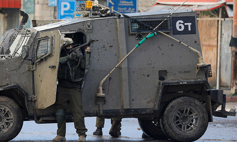 Israeli soldiers keep position on December 13 following an overnight army raid in Jenin in the occupied West Bank. &mdash; AFP