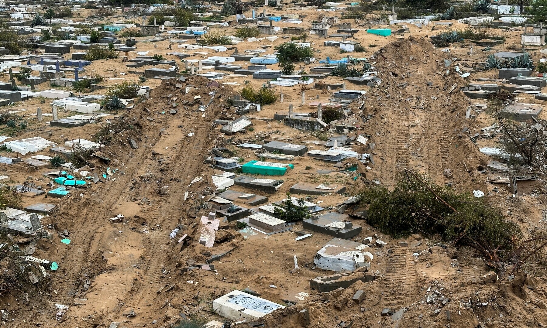  Graves damaged during the Israeli ground offensive are seen in the Fallujah neighbourhood, in Jabalia in the northern Gaza Strip, on Dec 13, 2023. &mdash; Reuters 