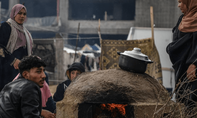 Palestinian families take refuge in the logistics base of UNRWA and in the makeshift tents they have built around the storage as they struggle with cold weather in Rafah. &mdash; Anadolu Agency