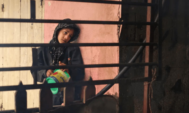 A Palestinian children waits for food at a charity kitchen in Rafah, southern Gaza Strip. &mdash; Reuters