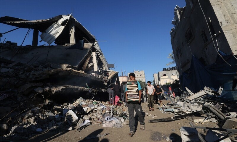Palestinians recover items from the rubble of a building destroyed following Israeli bombardment on Rafah, in the southern Gaza Strip, on December 15, 2023.&mdash;AFP