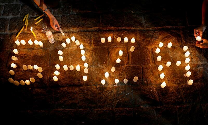 People light candles during a vigil in tribute to Palestinian children in Gaza in Brazil on December 15, 2023 &mdash; Reuters