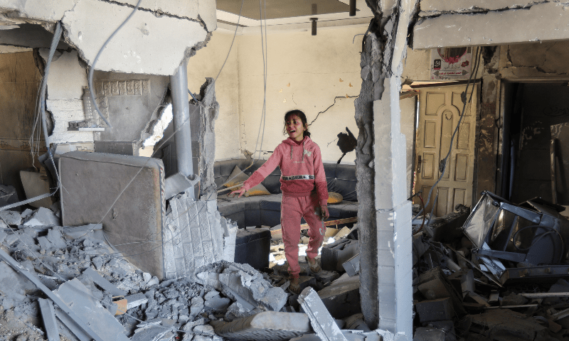  A Palestinian child reacts at the site of an Israeli strike on a house in Rafah in the southern Gaza Strip on Dec 16, 2023. &mdash; Reuters 