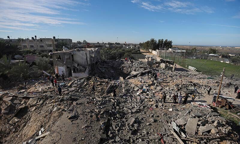 Palestinians inspect the site of an Israeli strike on a house, in Rafah, in the southern Gaza Strip on December 16, 2023 &mdash; Reuters