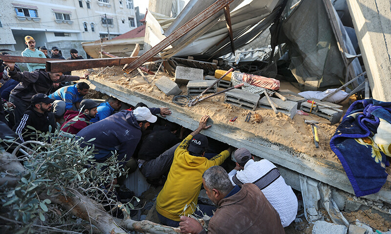  Palestinians inspect the site of an Israeli strike on a house, amid the ongoing Israeli bombardment in Rafah in the southern Gaza Strip, December 17, 2023.&mdash;Reuters