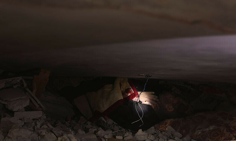 A casualty is seen amid the debris, at the site of an Israeli strike on a house, amid the ongoing Israeli bombardment in Rafah in the southern Gaza Strip, December 17, 2023.&mdash;Reuters