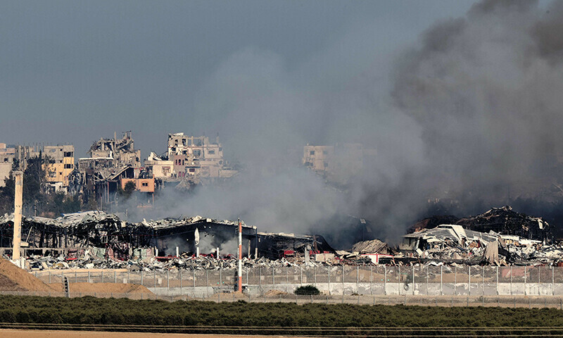 A picture taken in southern Israel near the border with the Gaza Strip on December 17, 2023, shows destruction and smoke in the north of the Palestinian.&mdash;AFP