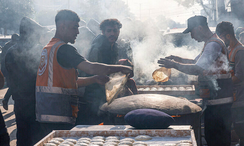 PHOTOS: Palestinians prepare traditional bread among destroyed houses in Rafah