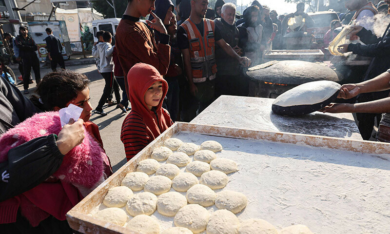 Palestinians prepare traditional unleavened bread in Rafah in the southern Gaza Strip on December 18, 2023. &mdash; AFP