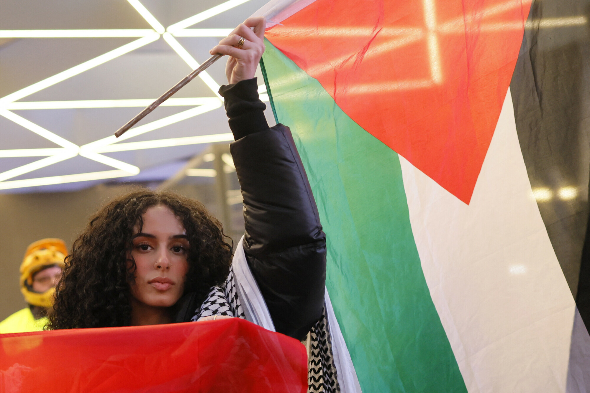  A pro-Palestine activist stops in front of Penn Station with a Palestine flag while marching in a Global Strike for Gaza on December 18, 2023 in New York City, New York. &mdash; AFP