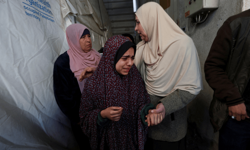 Mourners react near the bodies of Palestinians killed in Israeli strikes, at a hospital in Rafah, in the southern Gaza Strip, December 19. &mdash; Reuters