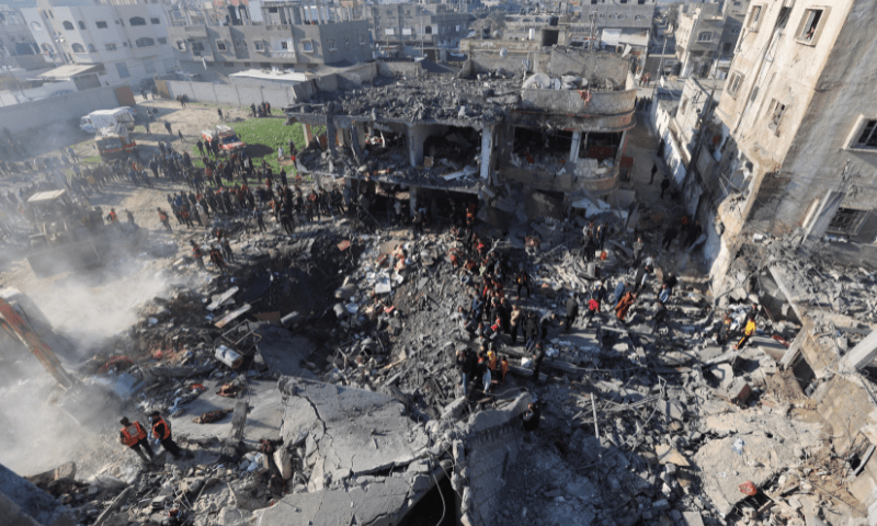 Palestinians gather at the site of an Israeli strike on a house in Rafah, in the southern Gaza Strip, December 19. &mdash; Reuters