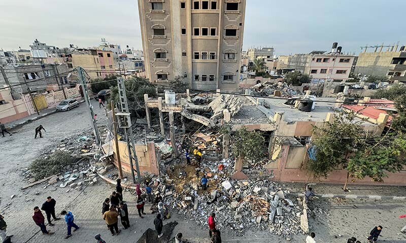 Palestinians gather at the site of an Israeli strike on a house in Khan Younis in the southern Gaza Strip on December 20, 2023. &mdash; Reuters