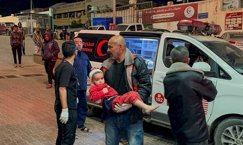 A Palestinian child wounded in an Israeli strike is rushed into Nasser hospital in Khan Younis in the southern Gaza Strip, December 20, 2023. &mdash; Reuters