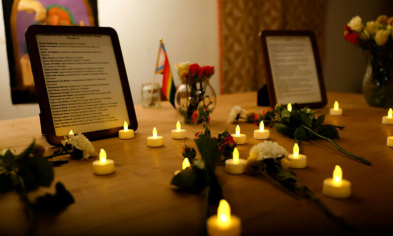 Candles are seen placed on a table during a candlelight vigil in honor of journalists and others who lost their lives in Baltimore, December 20, 2023. &mdash; Reuters
