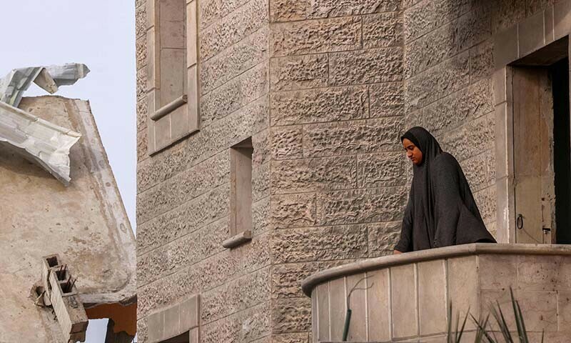 A Palestinian woman checks the rubble following Israeli bombardment in Khan Younis in the southern Gaza Strip on December 21, 2023 &mdash; AFP