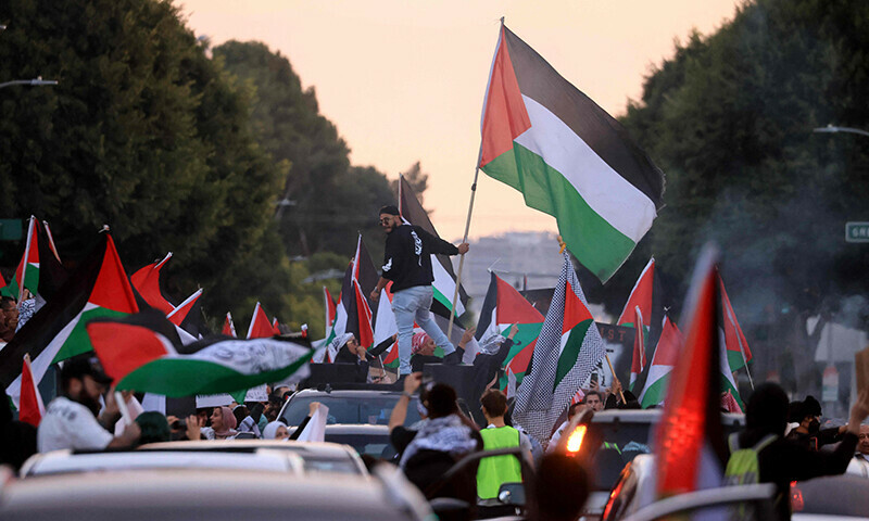 Protesters wave Palestinian flags as they rally during the &ldquo;Black &amp; Palestinian Solidarity for a Ceasefire this Xmas&rdquo; by the Beverly Center shopping centre in Los Angeles on December 23, 2023.&mdash;AFP