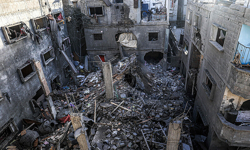 People inspect the rubble of a building destroyed by Israeli bombardment in Rafah in the southern Gaza Strip on December 24, 2023.&mdash;AFP