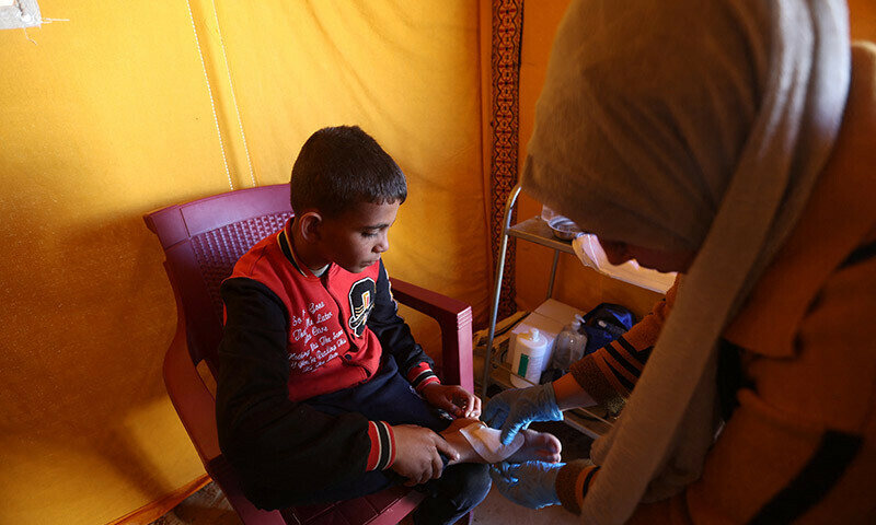 A displaced Palestinian boy receives treatment in a medical tent set up by volunteers in Rafah in the southern Gaza Strip, December 24, 2023. &mdash; Reuters