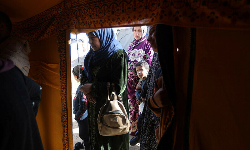 Displaced Palestinians wait to receive treatment in a medical tent set up by volunteers in Rafah in the southern Gaza Strip, December 24, 2023. &mdash; Reuters