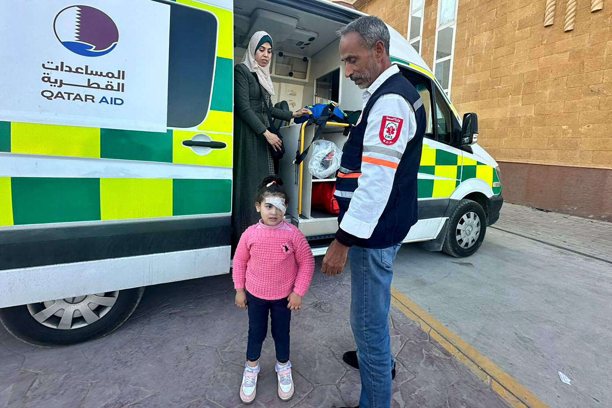 A wounded Palestinian child stands near an ambulance at the Rafah border crossing in Egypt after being evacuated from the Gaza Strip, on December 25. &mdash; AFP