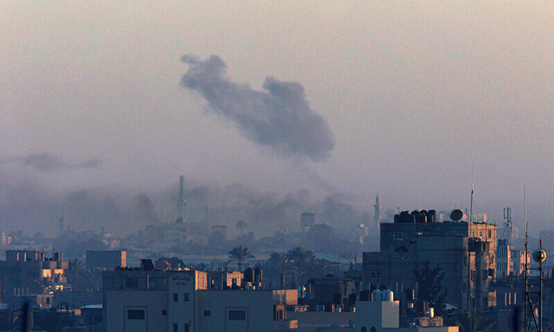 A picture taken from Rafah shows smoke billowing over Khan Yunis in the southern Gaza Strip during Israeli bombardment on December 26, 2023. &mdash; AFP