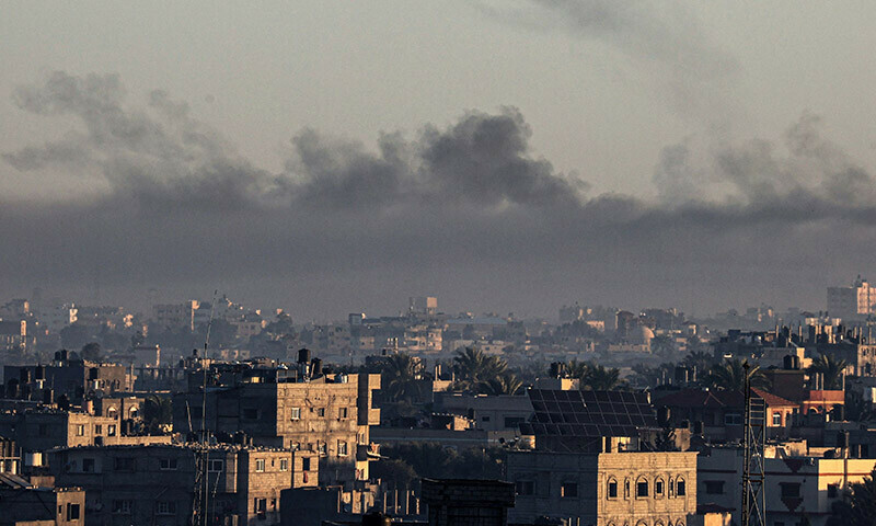 A picture taken from Rafah shows smoke billowing over Khan Yunis in the southern Gaza Strip during Israeli bombardment on December 26, 2023. &mdash; AFP