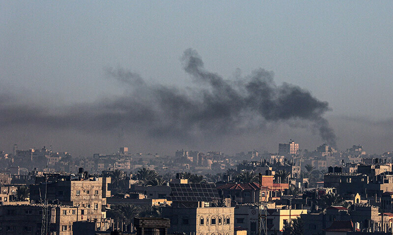 A picture taken from Rafah shows smoke billowing over Khan Yunis in the southern Gaza Strip during Israeli bombardment on December 26, 2023. &mdash; AFP