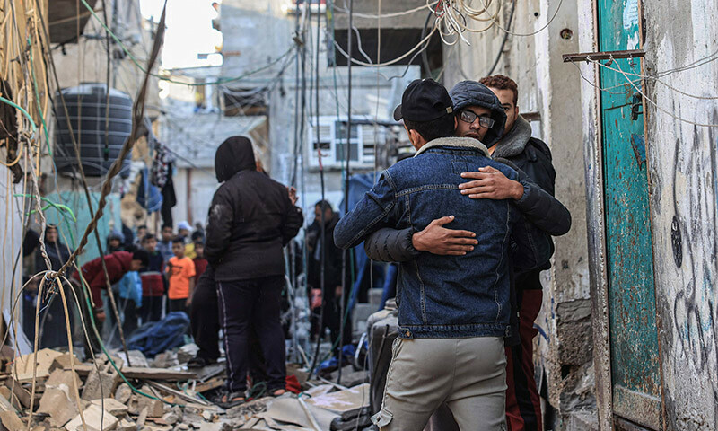Palestinians gather near the rubble of a building following Israeli bombardment in Rafah in the southern Gaza Strip on December 26, 2023. &mdash; AFP