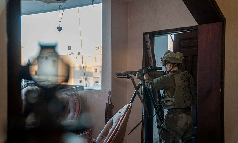 An Israeli soldier takes position in the Gaza Strip on December 27, 2023. &mdash; Reuters