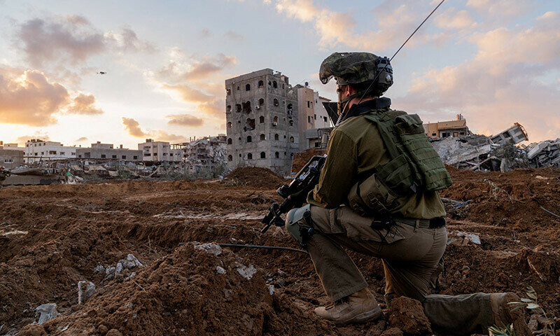 An Israeli soldier takes position in the Gaza Strip on December 27, 2023. &mdash; Reuters