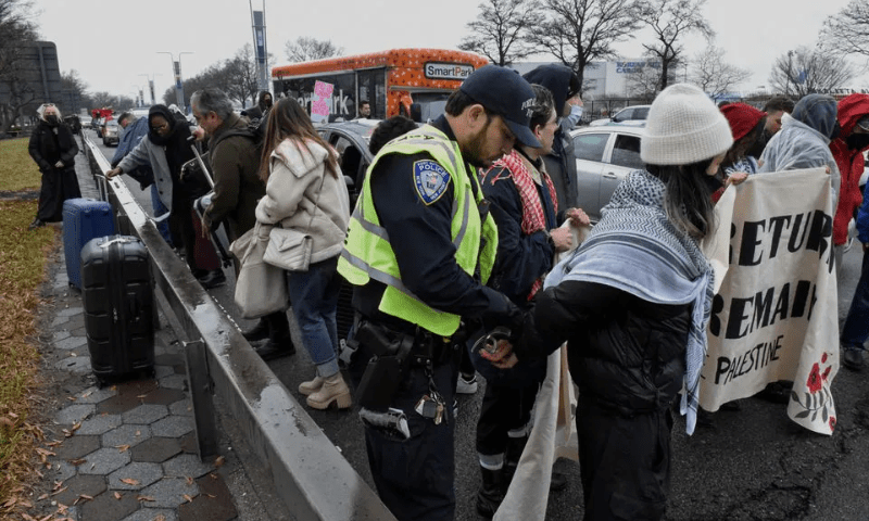 Pro-Palestinian demonstrators are detained by Port Authority police after blocking traffic on the road that leads to John F Kennedy airport (JFK) in New York City, US, December 27, 2023. &mdash; Reuters