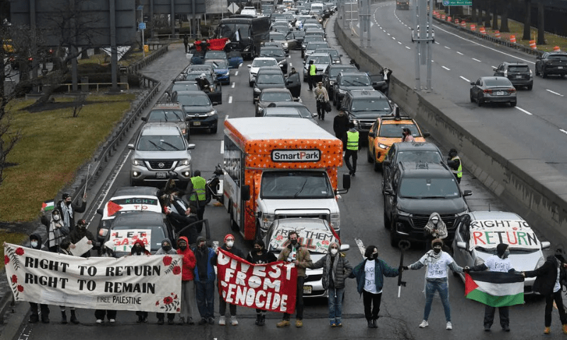 Pro-Palestinian demonstrators block traffic on the road that leads to John F Kennedy airport (JFK) in New York City, US, December 27, 2023. &mdash; Reuters
