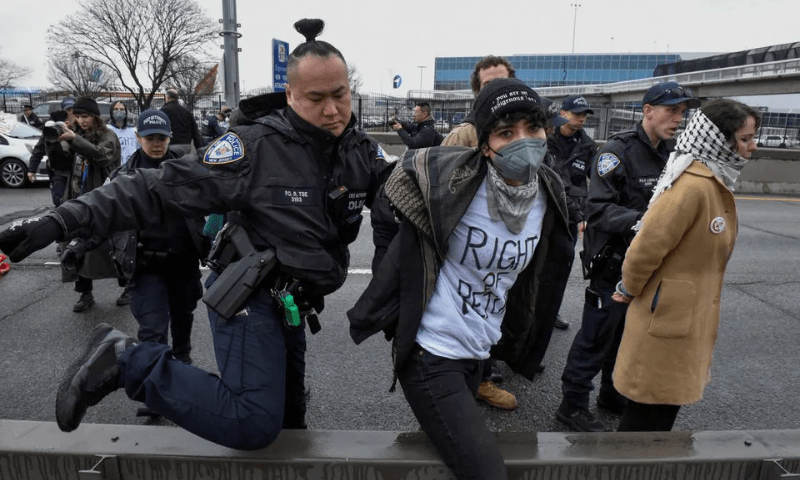 Pro-Palestinian demonstrators are detained by Port Authority police after blocking traffic on the road that leads to John F Kennedy airport (JFK) in New York City, US, December 27, 2023. &mdash; Reuters