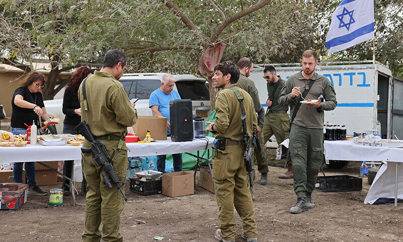 Israeli civilian volunteers cook for soldiers in southern Israel on the border with the Gaza Strip on December 28, 2023. &mdash; AFP
