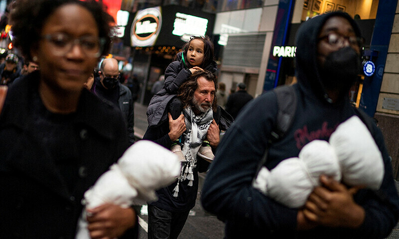 Pro-Palestinian demonstrators march around Times Square demanding a ceasefire&nbsp;during a protest in New York City, US December 28, 2023 &mdash; Reuters