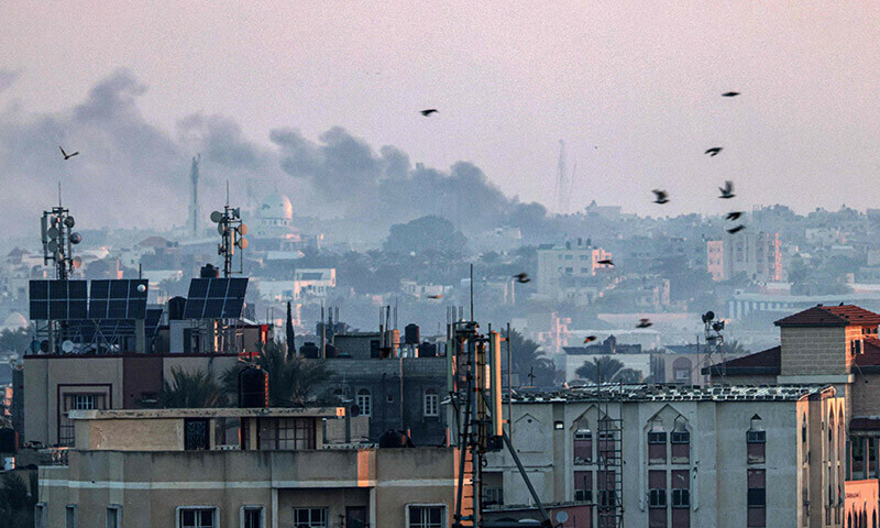 A picture taken from Rafah shows smoke billowing over Khan Yunis in the southern Gaza Strip during Israeli bombardment on December 30, 2023. &mdash; AFP
