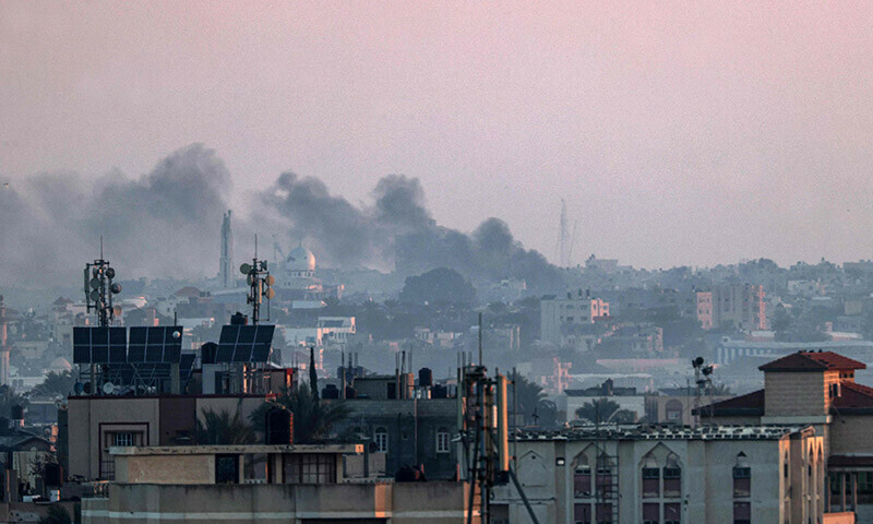 A picture taken from Rafah shows smoke billowing over Khan Yunis in the southern Gaza Strip during Israeli bombardment on December 30, 2023. &mdash; AFP