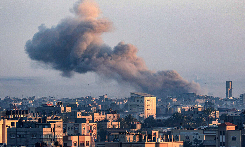 A picture taken from Rafah shows smoke billowing over Khan Yunis in the southern Gaza Strip during Israeli bombardment on December 30, 2023. &mdash;AFP