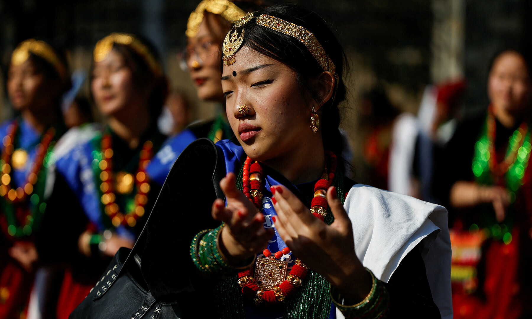 A woman wearing traditional attire dances as she takes part in a parade to celebrate Tamu Lhosar, a New Year festival of the Gurung community in Kathmandu, Nepal on Dec 31. — Reuters