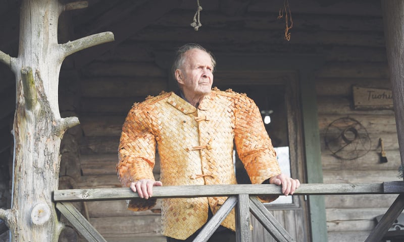 ASIKKALA (Finland): A man poses for a portrait in front of his shop, wearing a jacket he made from birch tree bark.—AFP ASIKKALA (Finland): A man poses for a portrait in front of his shop, wearing a jacket he made from birch tree bark.—AFP