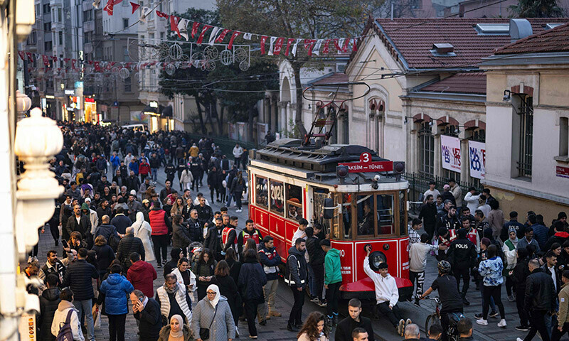 People ride a historical tramway at Taksim Square during preparations to celebrate the New Year 2024 in Istanbul on December 31, 2023. — AFP