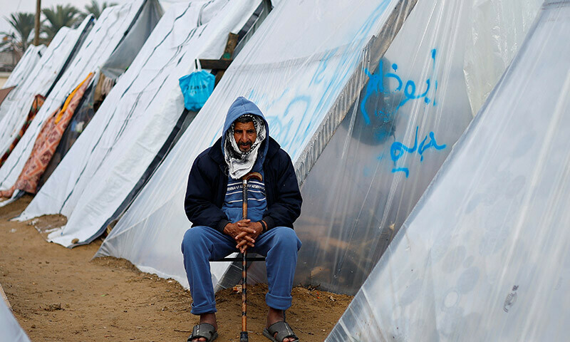 A Palestinian man sits, as displaced Palestinians, who fled their homes due to Israeli strikes, shelter at a tent camp in Rafah, southern Gaza Strip, January 2, 2024. &mdash; Reuters