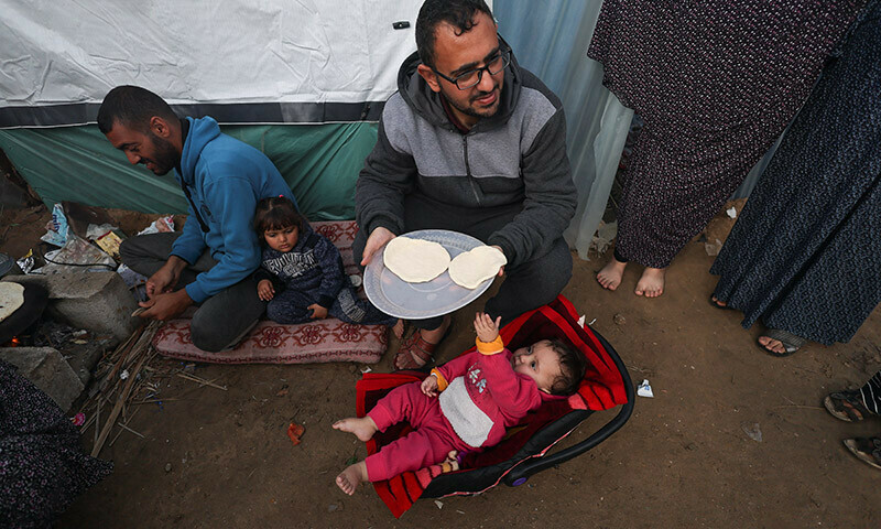 Displaced Palestinians, who fled their homes due to Israeli strikes, shelter at a tent camp in Rafah, southern Gaza Strip, January 2, 2024. &mdash; Reuters