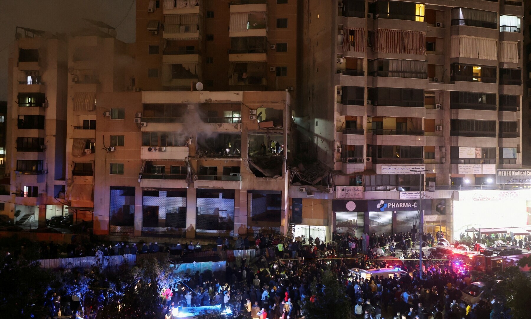  People gather near a damaged site following an explosion, in what security sources say is an Israeli drone strike, at the Beirut suburb of Dahiyeh, Lebanon on Jan 2, 2024. &mdash; Reuters 