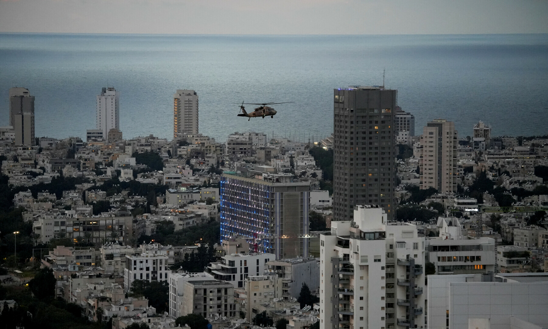  A military helicopter flies over Tel Aviv, Israel on Jan 3, 2024. &mdash; Reuters 