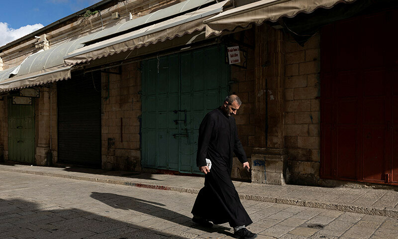A man walks past closed shops during a strike as a protest against the killing of senior Hamas official, Saleh al-Arouri, in Jerusalem&rsquo;s Old City. &mdash; Reuters
